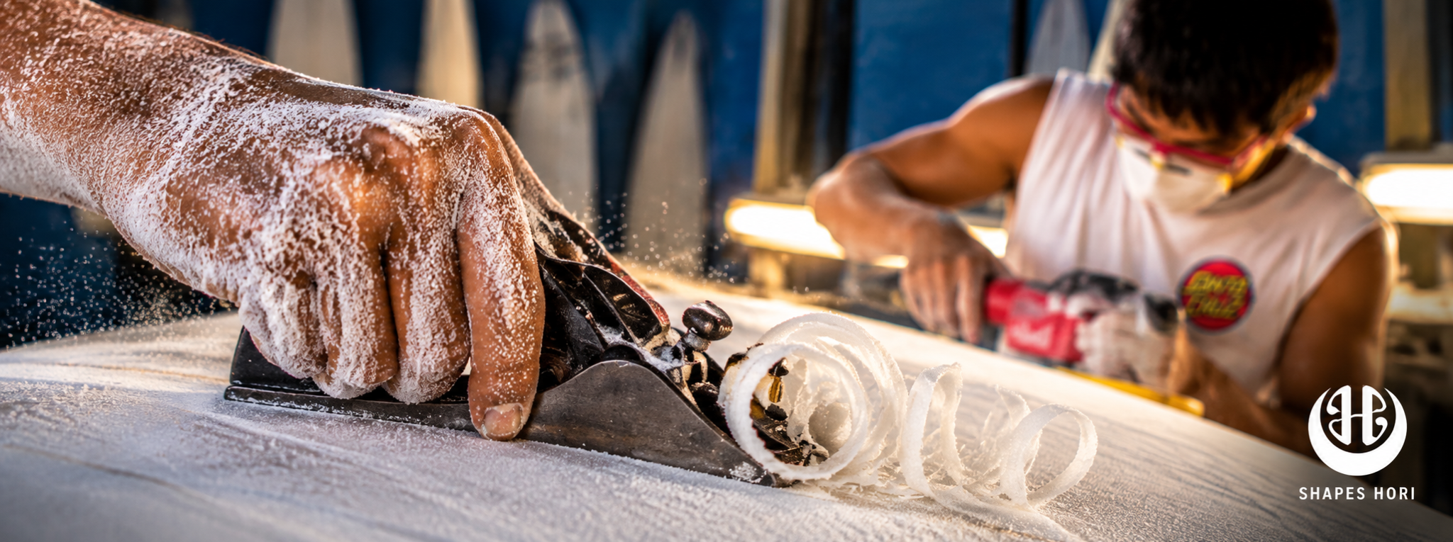 A Shapes Hori craftsperson shaping a surfboard in the workshop